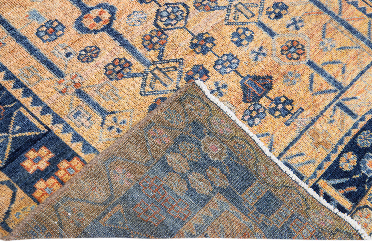 Backside of handmade blue and beige wool rug