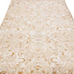 Zoomed out view of beige wool rug with floral designs and interwoven patterns